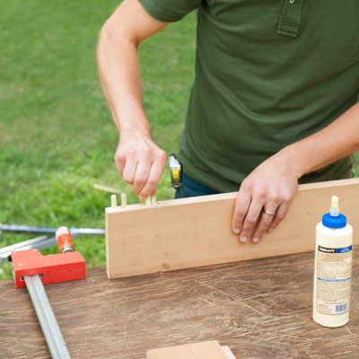 gluing dowels into rails for a picnic bench