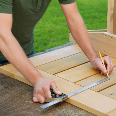 measuring for the location of the base for a picnic bench