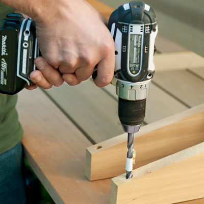 drilling countersink holes into the brackets for a picnic bench