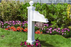 Address Plaque Post installed in a flower bed in front of a house
