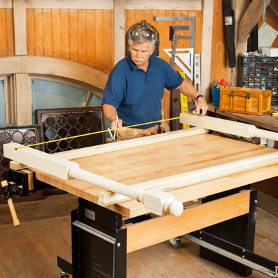 Tom Silva lays the newel posts across the top and bottom rails