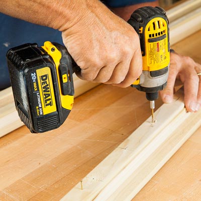 drilling pilot holes into the rail