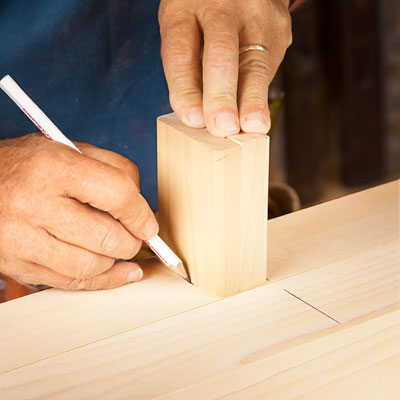 using a scrap piece of bottom rail to mark the attachment spot