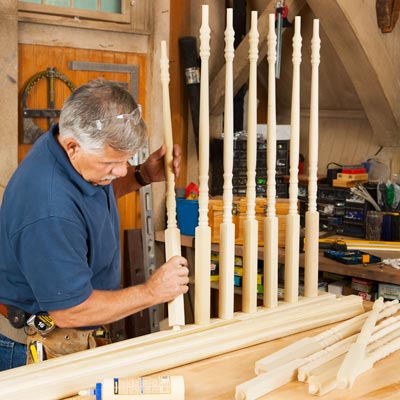 Tom Silva inserts balusters into the bottom rail