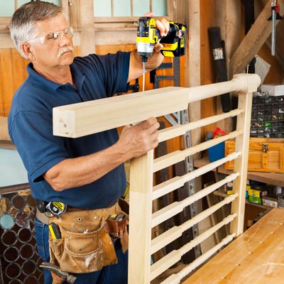 Tom Silva drives timber screws through the holes and into the ends of the rails