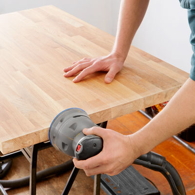 sanding the butcher-block with a random-orbit sander