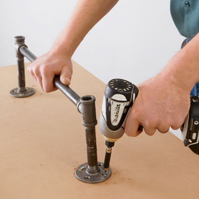 temporarily screwing the rung flanges to the work surface