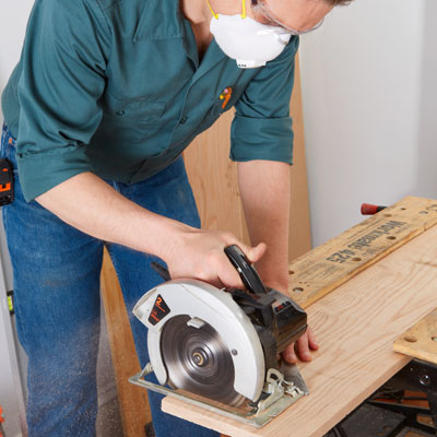 crosscutting the shelf board with a circular saw