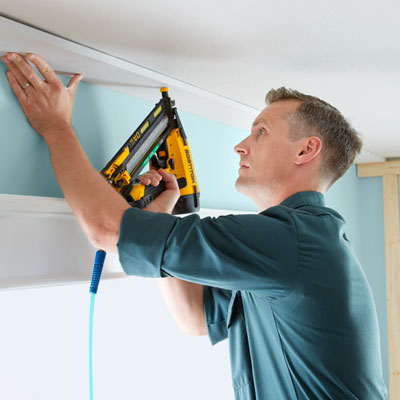 nailing a coffered ceiling's beam in place