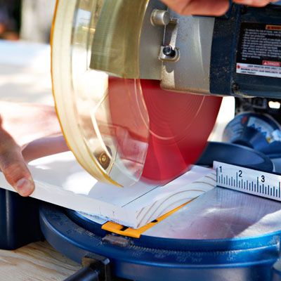 cutting the perimeter crossbeam with a miter saw