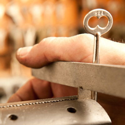 file notches in the key to match the wards in the keyhole, making a new skeleton key for an old mortise door lock