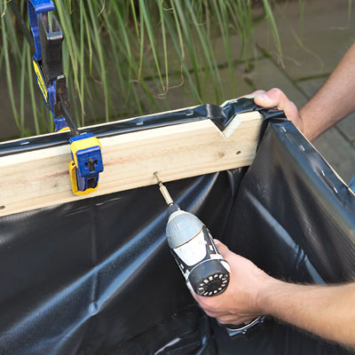 attaching the interior battens with a drill/driver to secure the pond liner