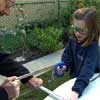 Slater Harrison and little girl cutting PVC with hacksaw