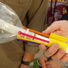 zip ties lining the rim of a 2-liter bottle on a piece of PVC pipe with duct tape wrapped around the ties