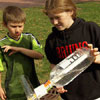 boy looks on as girl loads a bottle onto the PVC tubing filled a third of the way with water