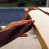 position the strips and stick the laminate to the substrate