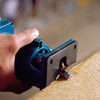 using the router turned on its side, cut off the overhanging edges of laminate, running the bit counterclockwise around the edges