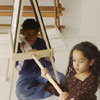 kids sliding paper roll to the easel