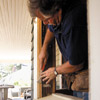 Scrape off all loose and blistered paint and patch any holes or cracks