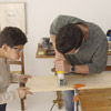 family cuts the top and the leg pieces to build step stool