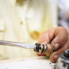 fastening a new washer with the new brass screw