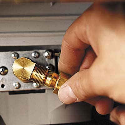 man sliding the nut and tightening it to the inlet