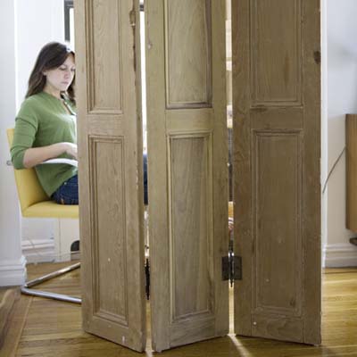 woman sitting behind unfolded screen