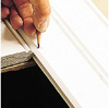 Marking cut lines with a pencil.