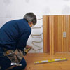 Tom Silva applying an adhesive before wainscoting 