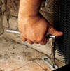 Screwing the door to the firebox floor.