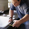 Richard Trethewey setting a kitchen sink