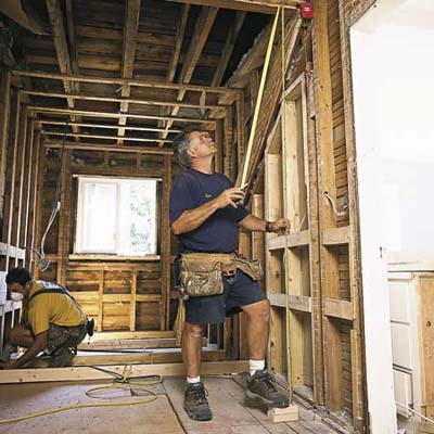 measuring the studs for a partition wall