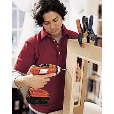 assembling radiator cover using clamps and drill