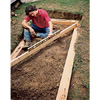 Setting the first course of timbers, using a drill/driver and level.