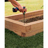 Assembling the bed's walls, using a drill/driver.