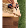 Installing the cap railing, using construction adhesive and a drill.