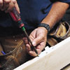 screwing on the hinges of a new door