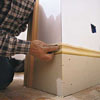 Tom Silva installing baseboard