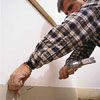 Tom Silva installing baseboard