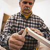 Tom Silva installing baseboard