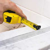 Centering the base track of a shower door 