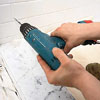 drilling holes for a shower door with a 3/16-inch-diameter masonry drill bit