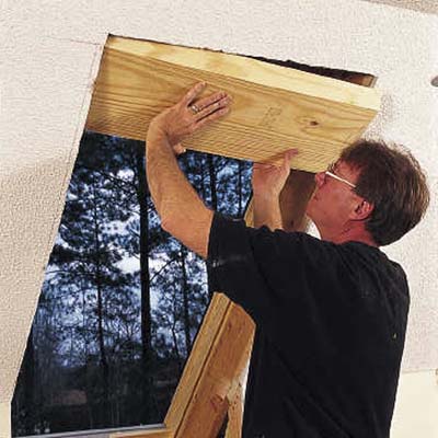cut a 2x12 header to fit into the space above the skylight