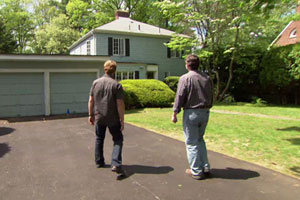 Norm Abram and Kevin O'Connor approach the Auburndale house before the beginning of renovation