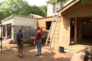 Tom Silva and Norm Abram in the back yard of the Auburndale house during renovation