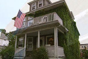 the East Boston house project before renovation begins creeping vines are prominent