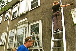 Roger Cook supervises the taking down the ivy from the East Boston house project