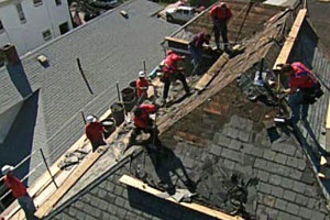 working on the roof of the East Boston house project