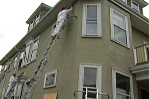 working on the exterior of the East Boston house project