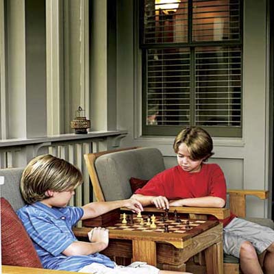 Two boys playing board game on the porch